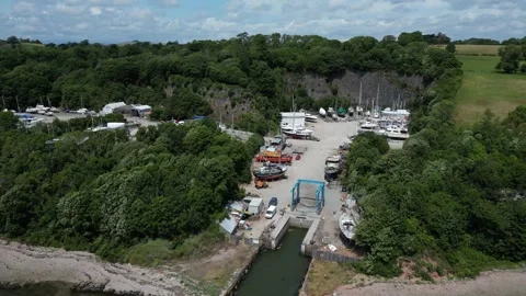 Galmpton Creek, Devon, England: DRONE VIEWS: Creek riverfront &amp; Drydock moorings Stock Footage 244718295
