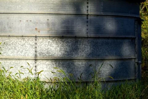 Galvanized bin in the green grass Foto stock