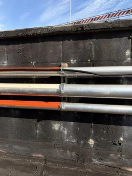 Galvanized Electrical Conduit System with Junction Box on Commercial Rooftop Stock Photos