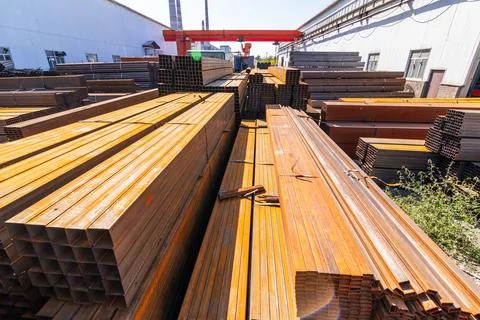 Galvanized iron pipes stack and steel rectangular bars of metal Stock Photos