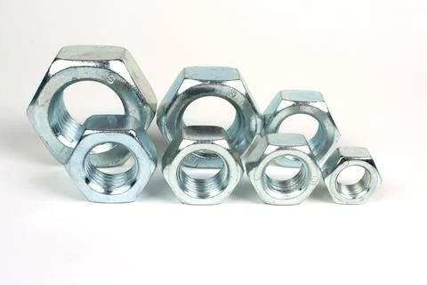 Galvanized metal nuts of different sizes close-up Stock Photos