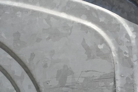 Galvanized metal surface with embossed patterns. Stock Photos