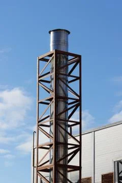 Galvanized pipe in metal protective case against the blue sky. Stock Photos