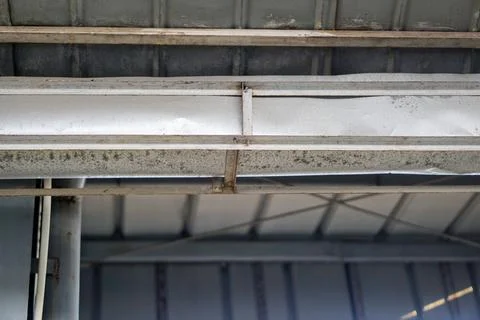 Galvanized rain gutter installation and electrical wiring beneath Fotos de archivo