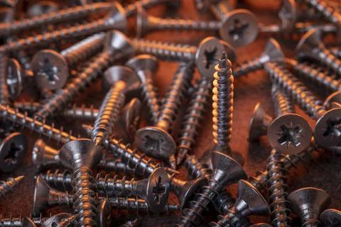 Galvanized screw in a creative color script Stock Photos