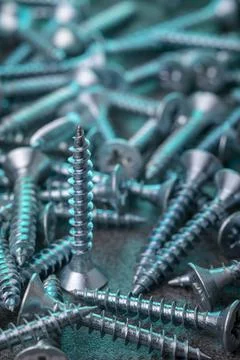 Galvanized screw in a creative color script Stock Photos