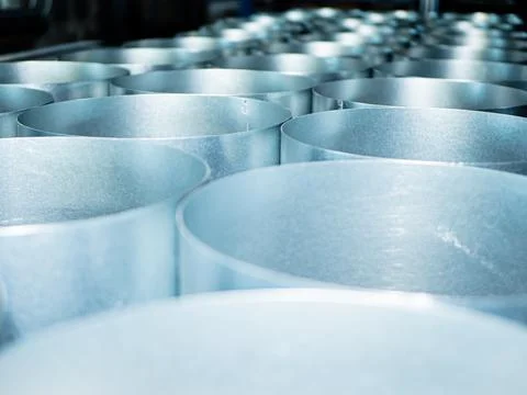 Galvanized sheet metal welded in round tubes for metalworking Stock Photos