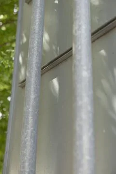 Galvanized twin poles feature subtle urban patterns and reflections 스톡 사진