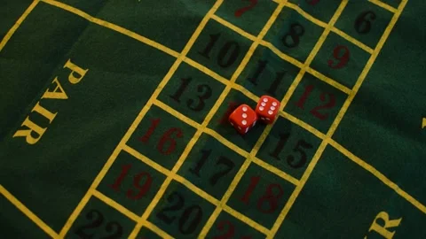 Gambler puts two red dice on the casino green table. Stock Footage 211617236