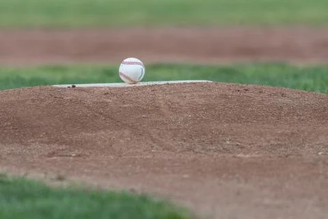 Game ball is on the baseball diamond. Stock Photos