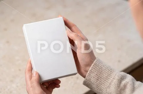 Game box mockup held by a person PSD Template