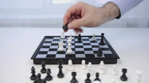 Game of chess. The black pawn defeats the white king. Man makes a winning move Stock Footage 130690939