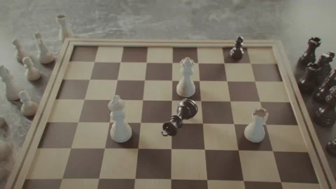 The game of chess. Checkmate, game over. King falls. Close-up macro shot of Stock Footage 225332612