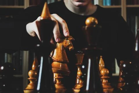 Game of chess. The guy makes a knights move. Wooden chess pieces. Strategy game Foto stock