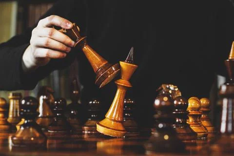 Game of chess. The guy makes a move. Checkmate. Wooden chess pieces. Strategy  Stock Photos