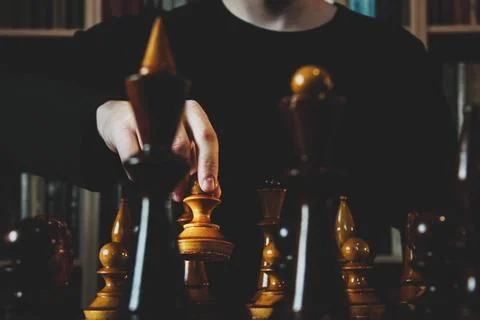 Game of chess. The guy makes a pawn move. Wooden chess pieces. Strategy game Stock Photos
