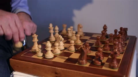Game of chess. The men move the chessboard. Chess board close-up Stock Footage 148324826
