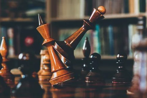 Game of chess. The queen and the king in a duel. The black lady beats  Stock Photos