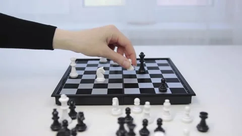 Game of chess. The white pawn defeats the black king. Woman makes a winning move Stock Footage 130690714