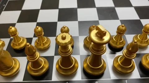 Game concept: Golden colored chess pieces arranged for opening match - close up Video stock 333183424