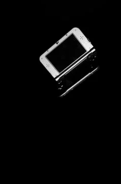 Game console on a black background. Stock Photos