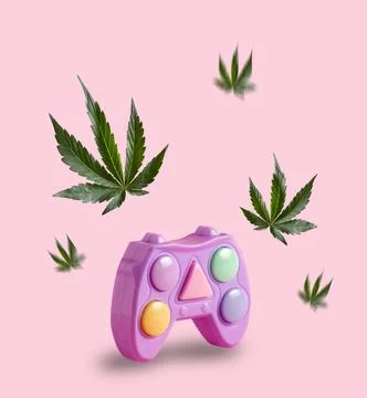Game console joystick and marijuana leaves flying around. Minimal art poste.. Stock Photos