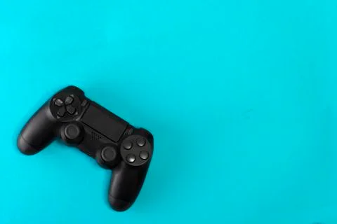 Game controller on blue background studio shot. Stock Photos