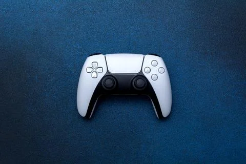 Game controller on a blue background. White joystick for computer games top v Stock Photos