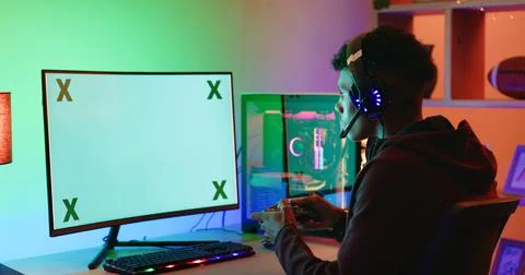 Game controller, computer screen and teen with headphones in home for espor.. Stock Photos