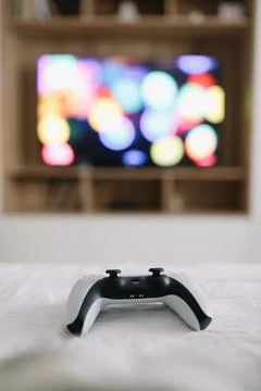 Game controller, joystick on TV screen background. Playing game console, weekend Foto stock