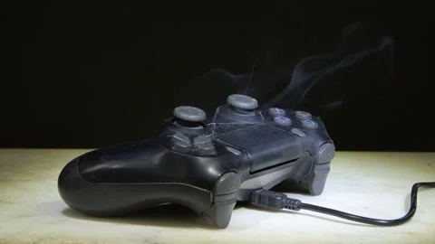 A game controller in is a symbol of overheating electronics and breakdown. Stock Footage 309485472