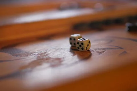 Game cubes lie on backgammon Stock Photos