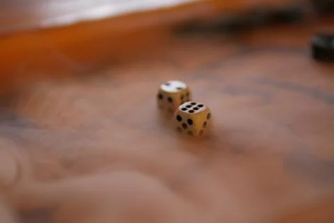Game cubes lie on backgammon in smoke Stock Photos