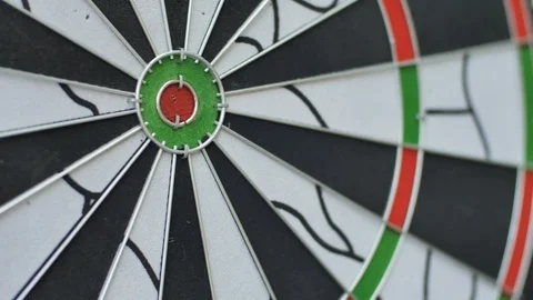 Game of darts. Two darts hit the bull's eye on the target Stock Footage 99321351