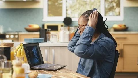 Game developer on laptop multitasking with visual effects and listening to music Stock Photos