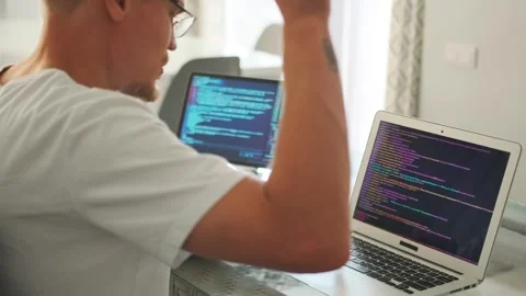 Game developer streams code, showing changes during video call. Stock Footage 294299305