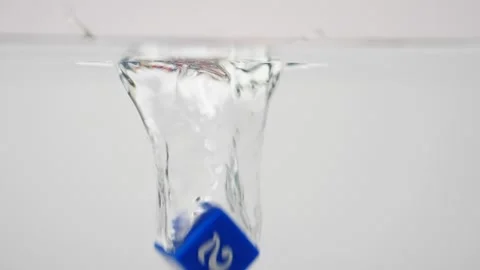 Game dice falling in slow motion in water splashing blue dice Stock Footage 219520757