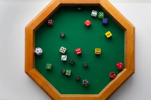 Game dice randomly placed in a green felt dice tray Stock Photos