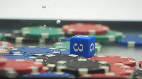 Game dies falling on poker chips through the water in slow motion Stock Footage 219520758
