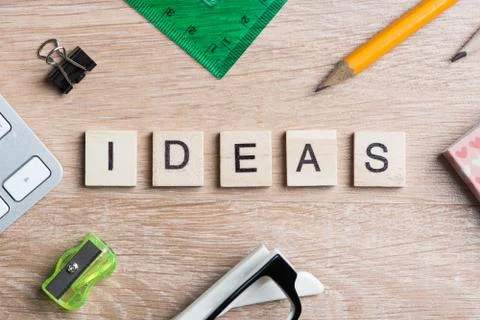 Game elements on wooden table spelling brainstorming and creative thinking idea Stock Photos