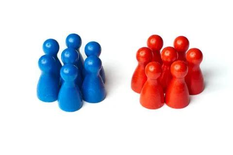 Game figures as a symbol for two groups of people. Concept for teamwork or Stock Photos