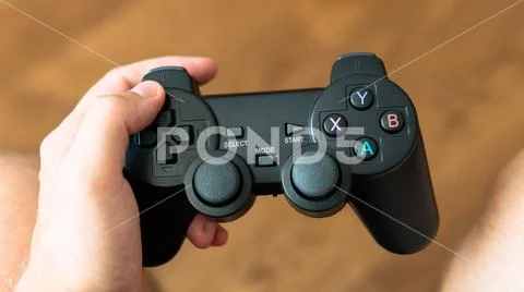 Game joystick from the console in male hands. Modern gaming technology Stock Photos