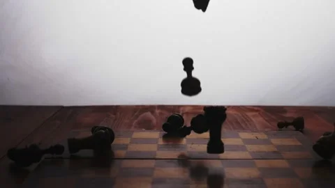 The game is over. Slow motion Chess pieces fall on the chessboard and scatter on Stock Footage 233031431