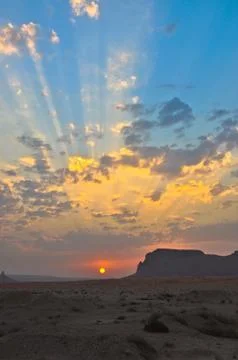 Game of rays at sunset among small clouds Stock Photos