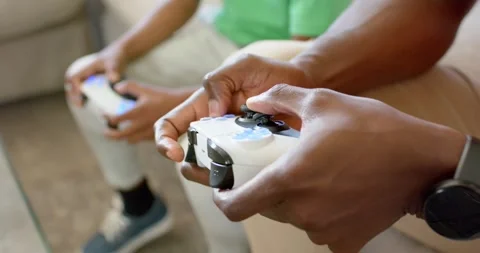Game starting, front hands are rotating right stick and pressing blue buttons on Stock Footage 337224781