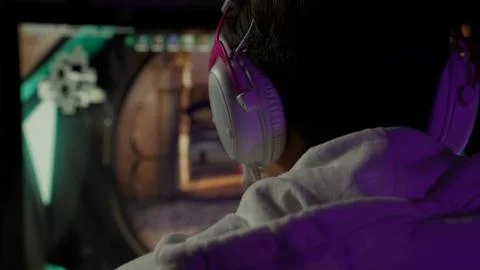 Game streamer using pc setup playing multiplayer first person shooter Stock Photos