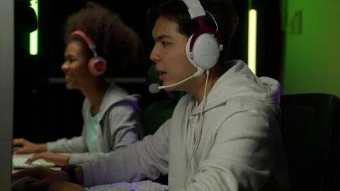 Game streamer using pc setup playing multiplayer first person shooter Stock Photos