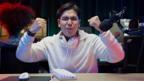 Game streamer using pc setup playing multiplayer first person shooter Stock Photos