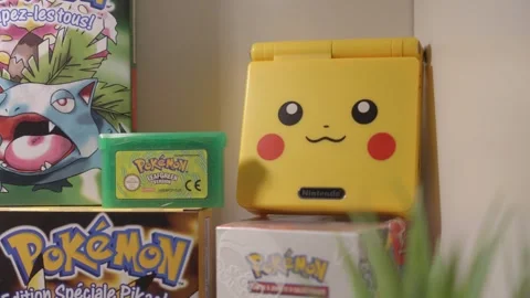 Gameboy SP console with Pokemon Yellow design on display Stock Footage 334656827