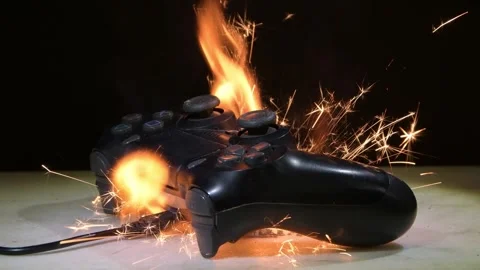 Gamepad exploding and catching fire on the table is a danger of modern gaming de Stock Footage 309485570